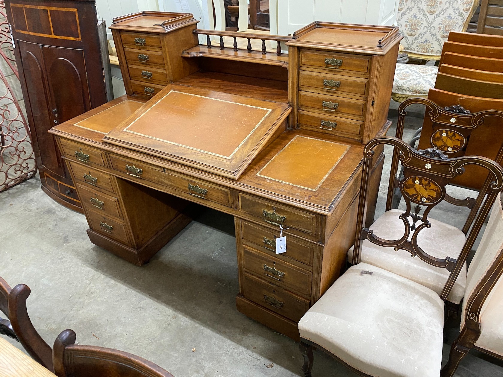 A late Victorian mahogany pedestal desk with hinged slant front, width 137cm, depth 73cm, height 113cm